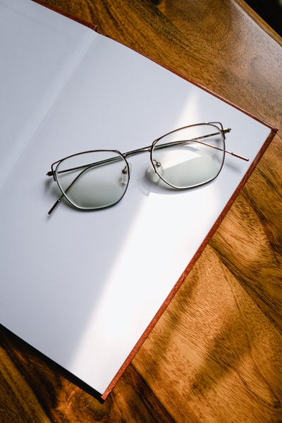 White black-rimmed glasses on the table
